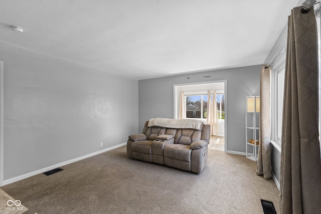 carpeted living room featuring baseboards and visible vents