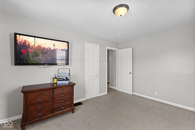 carpeted bedroom featuring baseboards