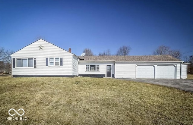 single story home featuring a chimney, a front yard, aphalt driveway, and an attached garage