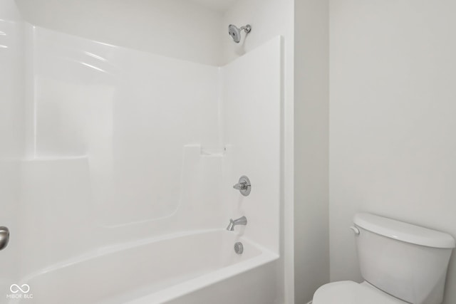 bathroom featuring toilet and  shower combination