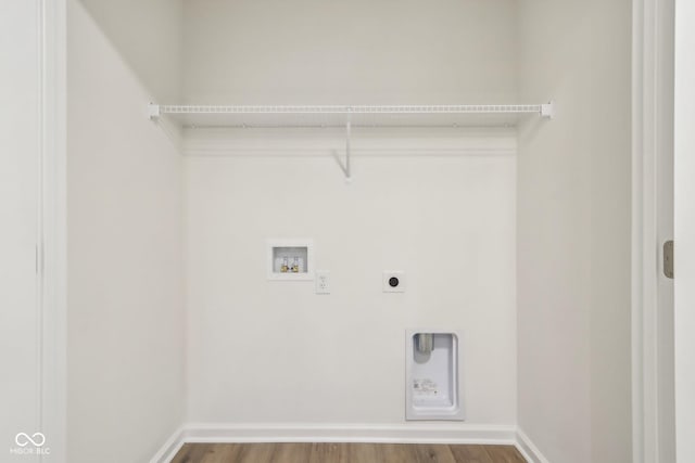 clothes washing area featuring washer hookup, hardwood / wood-style floors, and electric dryer hookup