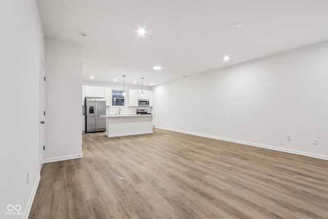 unfurnished living room featuring light wood-type flooring