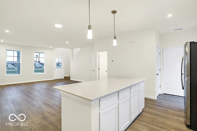 3921 Wren Dr, Brownsburg, IN 46112 - kitchen with freestanding refrigerator, white cabinetry, recessed lighting, wood finished floors, and a center island