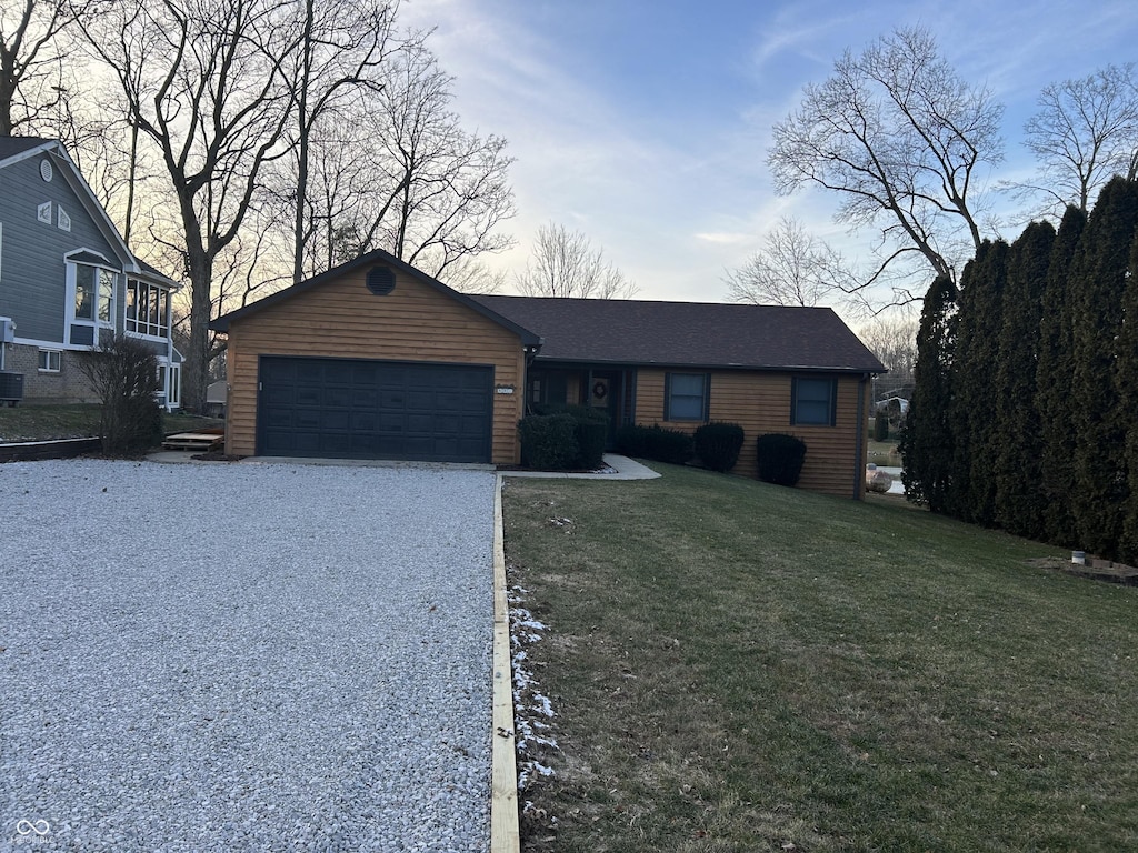 single story home with a lawn