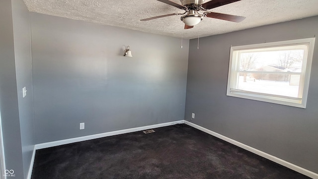 spare room featuring a textured ceiling and ceiling fan