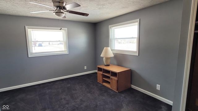 interior space with a textured ceiling and ceiling fan