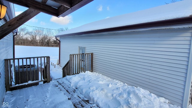 view of snow covered exterior featuring central air condition unit