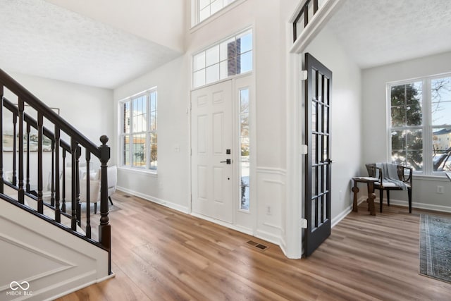 entryway with a textured ceiling and hardwood / wood-style flooring