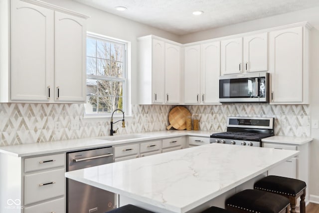 kitchen with white cabinetry, sink, and appliances with stainless steel finishes