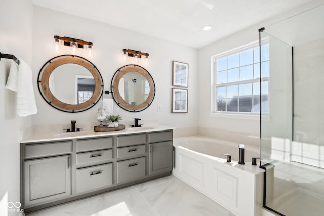 bathroom featuring vanity and a bath