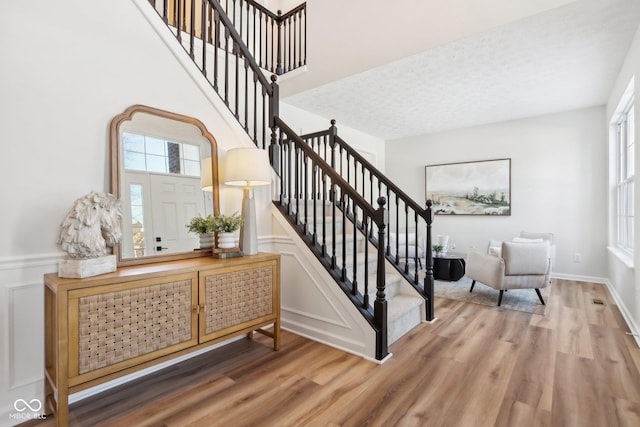 staircase with hardwood / wood-style floors