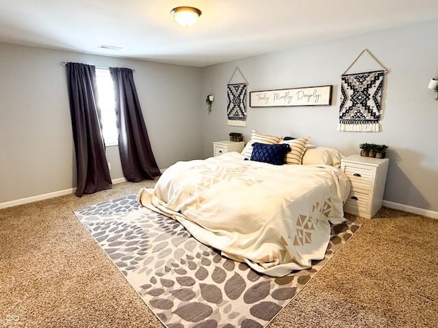 bedroom featuring light colored carpet, visible vents, and baseboards