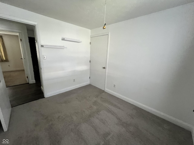 unfurnished room featuring carpet