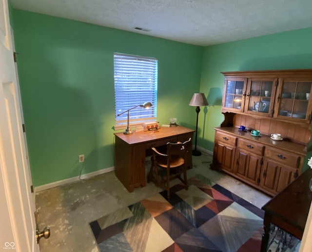 office space with a textured ceiling