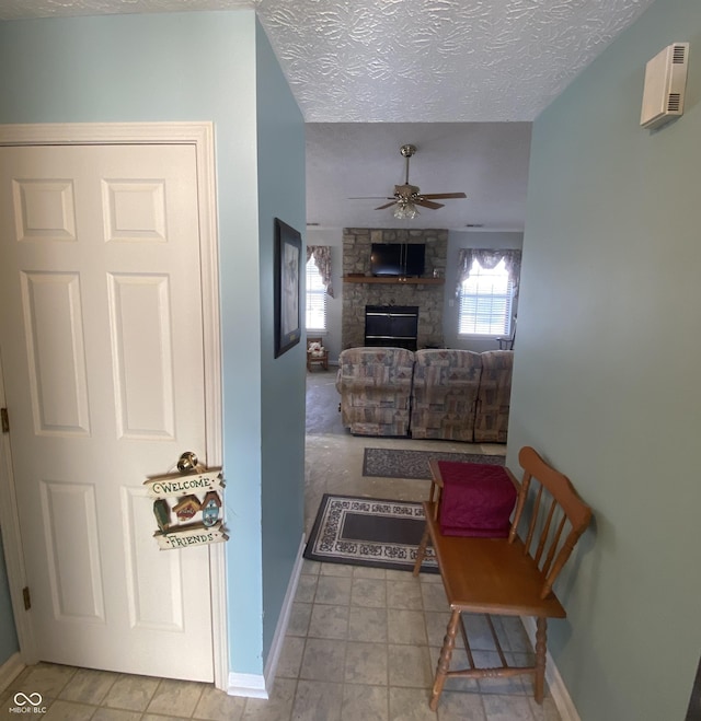 hall featuring a textured ceiling