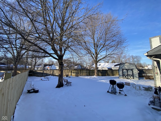 snowy yard with a shed