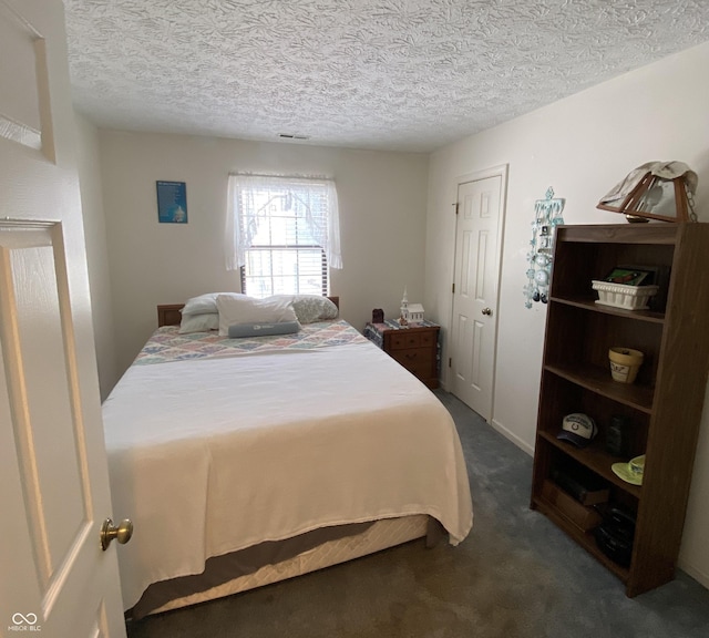 carpeted bedroom featuring a textured ceiling