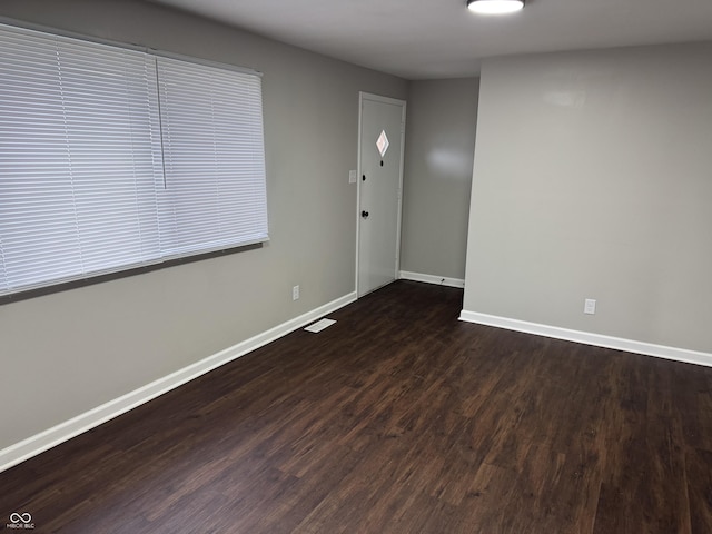 spare room with dark hardwood / wood-style floors