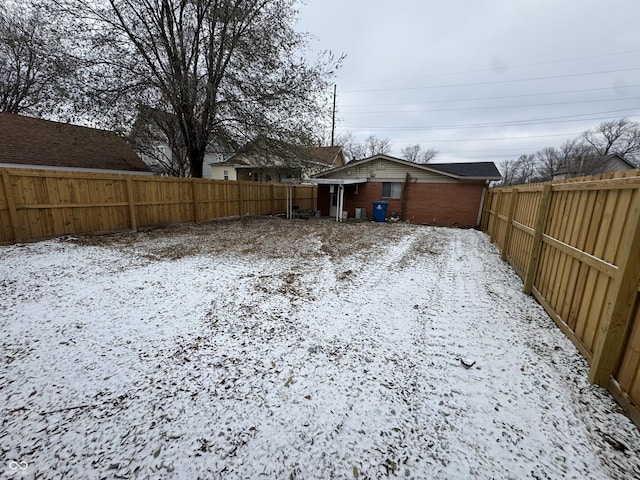 view of yard layered in snow