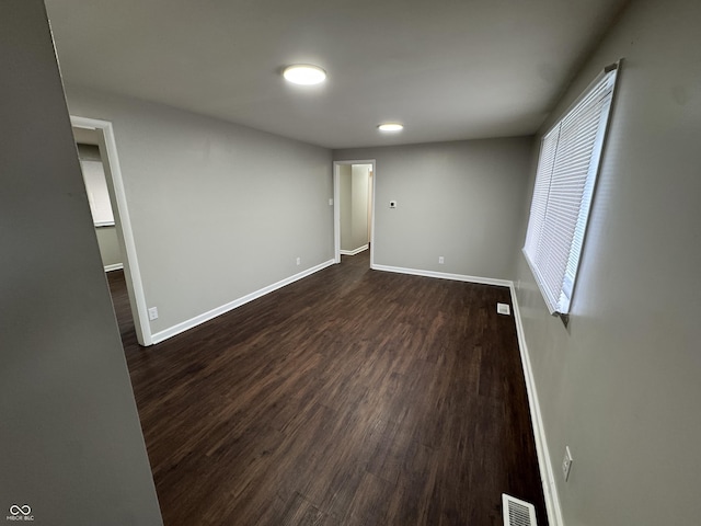 unfurnished room with dark hardwood / wood-style floors