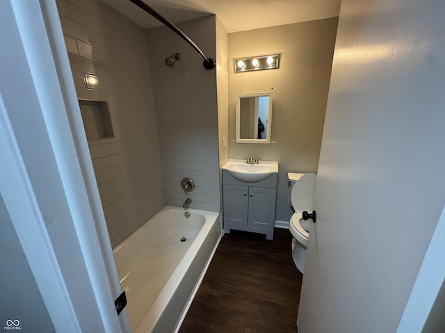 full bathroom featuring wood-type flooring, vanity, toilet, and tiled shower / bath