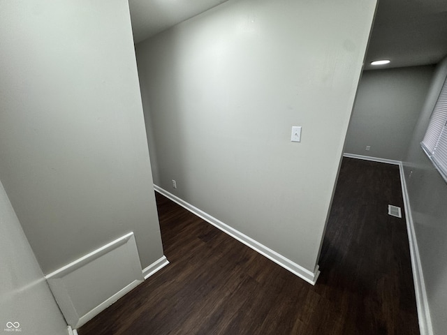 hall with dark hardwood / wood-style flooring