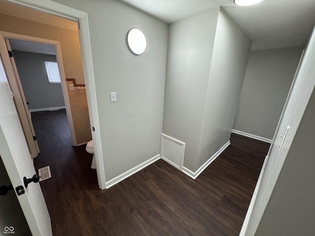 hall with dark hardwood / wood-style flooring