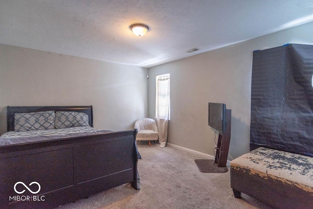 bedroom featuring carpet and a textured ceiling