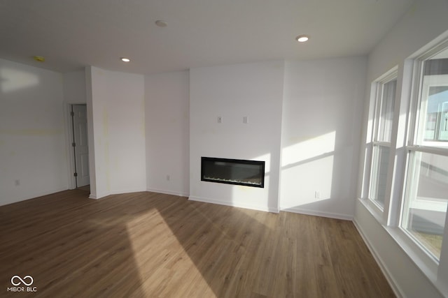 unfurnished living room with dark hardwood / wood-style floors