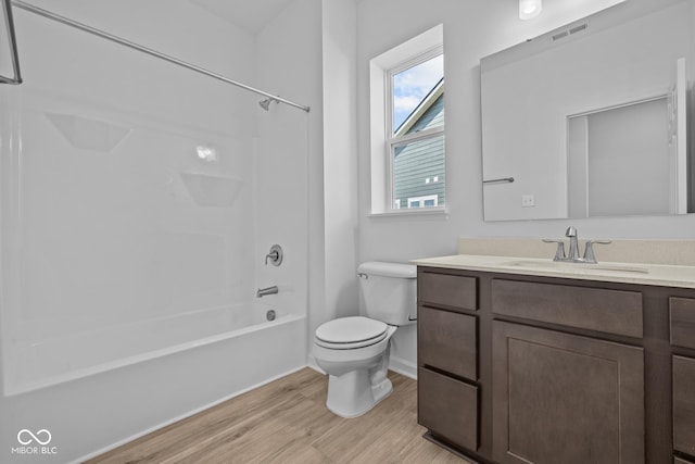 full bath featuring visible vents, tub / shower combination, toilet, wood finished floors, and vanity