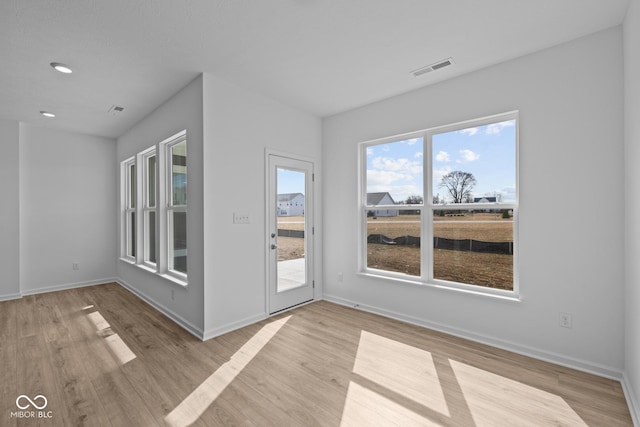 unfurnished room with recessed lighting, visible vents, baseboards, and light wood-style floors