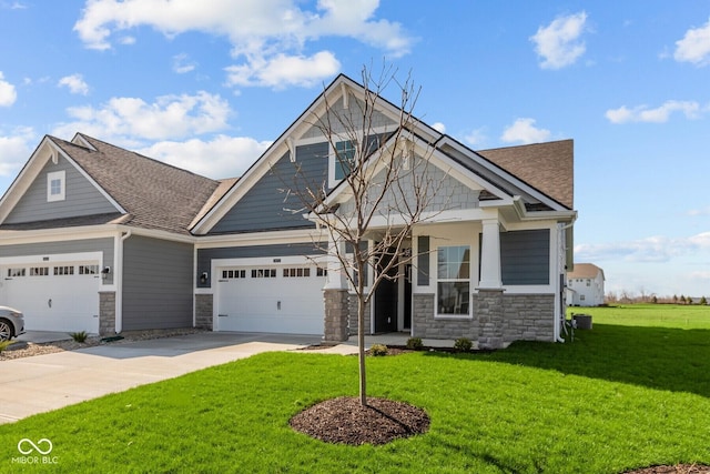 16673 Cattle Hollow Ln, Noblesville, IN 46060 - craftsman-style home featuring stone siding, a front lawn, concrete driveway, and a shingled roof