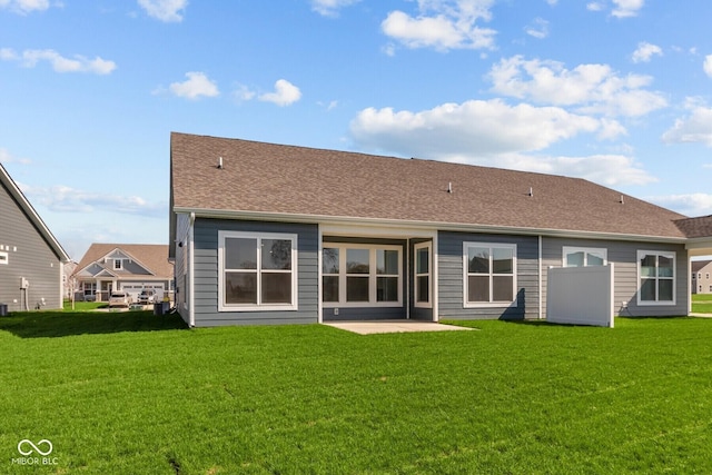 16673 Cattle Hollow Ln, Noblesville, IN 46060 - back of house featuring a lawn, a shingled roof, and a patio