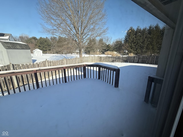 view of snow covered back of property