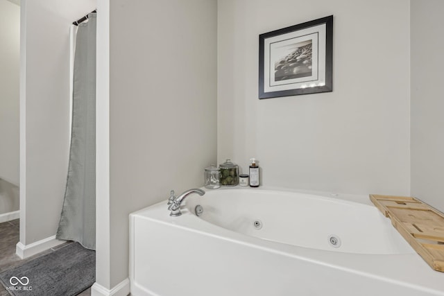 6595 Reserve Dr, Indianapolis, IN 46220 - bathroom featuring a whirlpool tub and baseboards