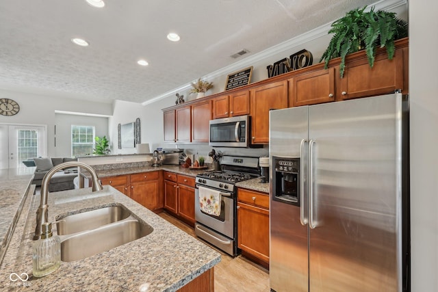 6595 Reserve Dr, Indianapolis, IN 46220 - kitchen featuring appliances with stainless steel finishes, a sink, recessed lighting, crown molding, and brown cabinets