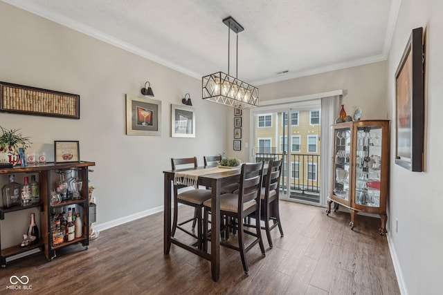 6595 Reserve Dr, Indianapolis, IN 46220 - dining room with dark wood-type flooring, baseboards, crown molding, and a chandelier