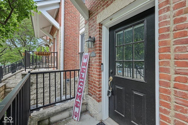 6595 Reserve Dr, Indianapolis, IN 46220 - view of exterior entry featuring brick siding and covered porch