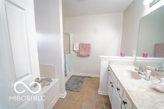 bathroom with vanity and a bath