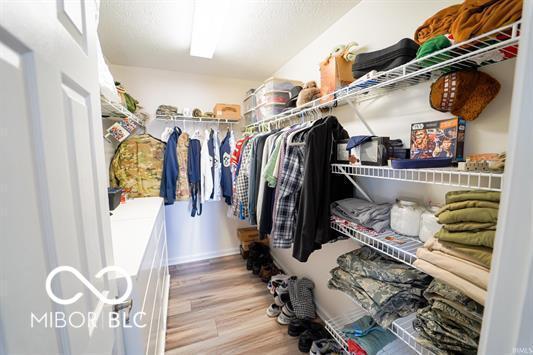 spacious closet featuring hardwood / wood-style flooring