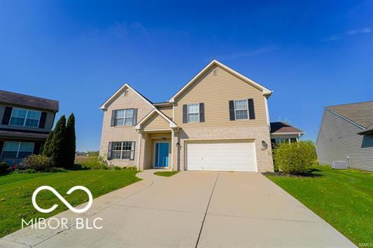 view of front property with a front lawn and a garage