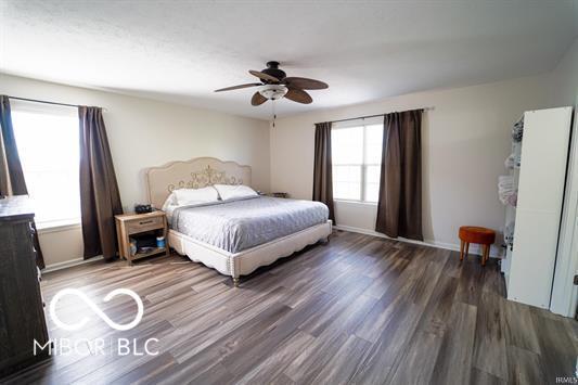 bedroom with ceiling fan and dark wood-type flooring