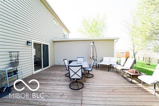 wooden terrace with an outdoor hangout area