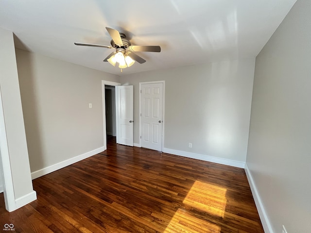 empty room with wood finished floors, baseboards, and ceiling fan