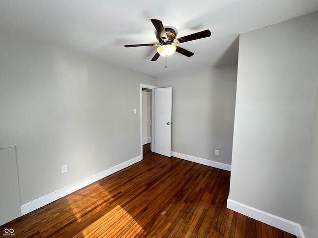 empty room featuring a ceiling fan, wood finished floors, and baseboards