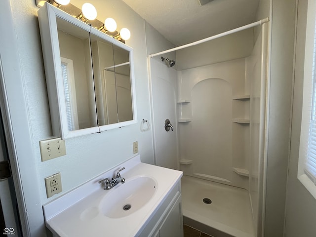 bathroom featuring vanity and a stall shower