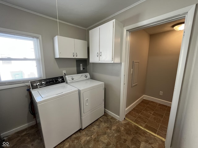 laundry area featuring baseboards, cabinet space, washing machine and dryer, and crown molding