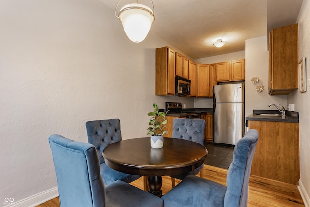 dining room featuring sink and hardwood / wood-style flooring