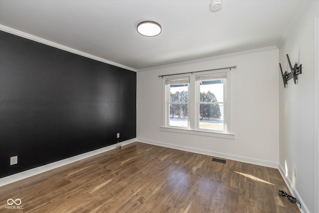 spare room with dark hardwood / wood-style flooring and ornamental molding