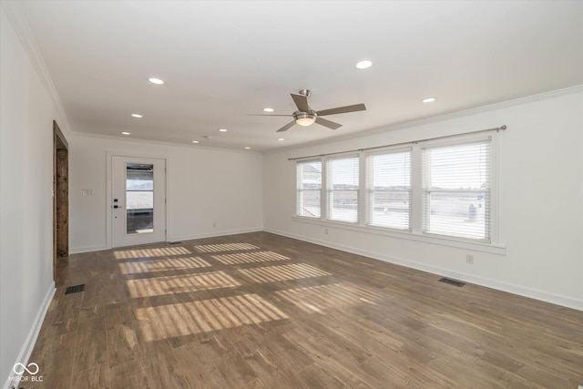 empty room with a wealth of natural light, ornamental molding, and ceiling fan